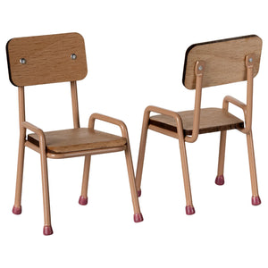 Two wooden chairs with metal legs on a white background