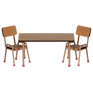 Wooden table with two matching chairs on a white background