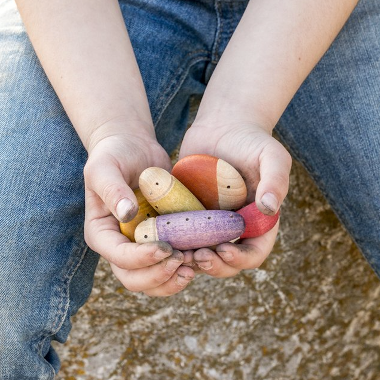 child holding Grapat insects in their hands