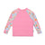 Pink long-sleeve swim rashie with floral sleeves on a white background