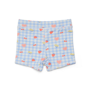 Swim shorts with a blue checkered pattern and heart and cherry design on a white background