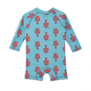Children's swimsuit with red lobster pattern on a blue background