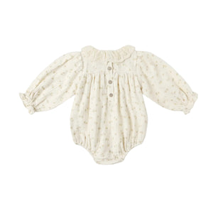 Cream-colored baby romper with long sleeves on a white background