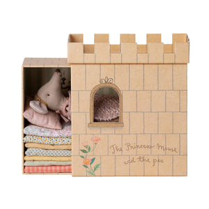 Toy castle with plush toys and fabric inside, branded 'The Princess Mouse and the Pea'.