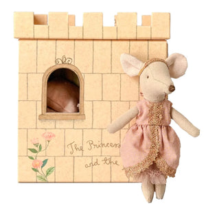 Toy mouse in a pink dress standing next to a small castle with 'The Princess and the Pea' text.