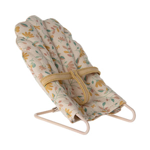 Toy baby bouncer with floral pattern on a white background