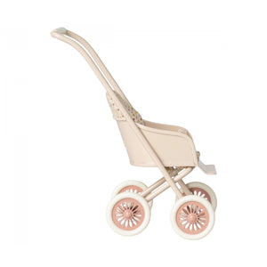 Beige and pink stroller on a white background