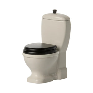 White toilet with black seat on a white background