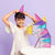 Child with colorful geometric art piece against a purple background