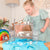 Child playing with a toy Arctic scene on a table
