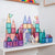 Colorful magnetic building blocks on a white shelf with toy horses.