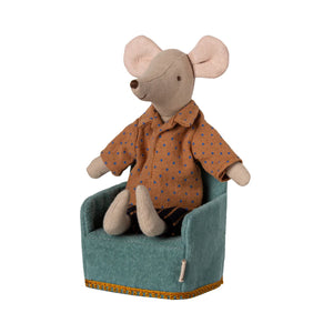 Stuffed mouse toy wearing a brown shirt sitting on a green chair with a white background