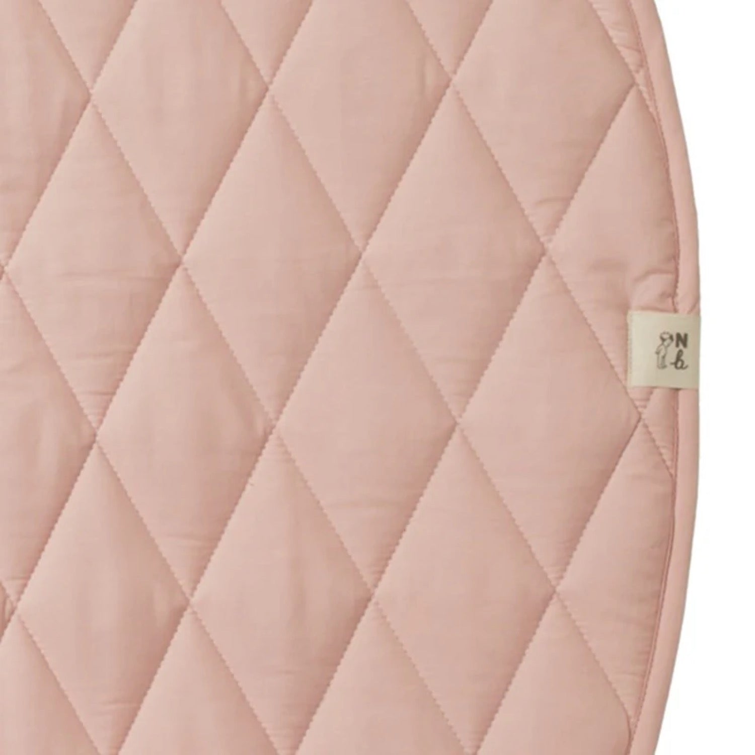 Quilted pink fabric with a brand label on a white background