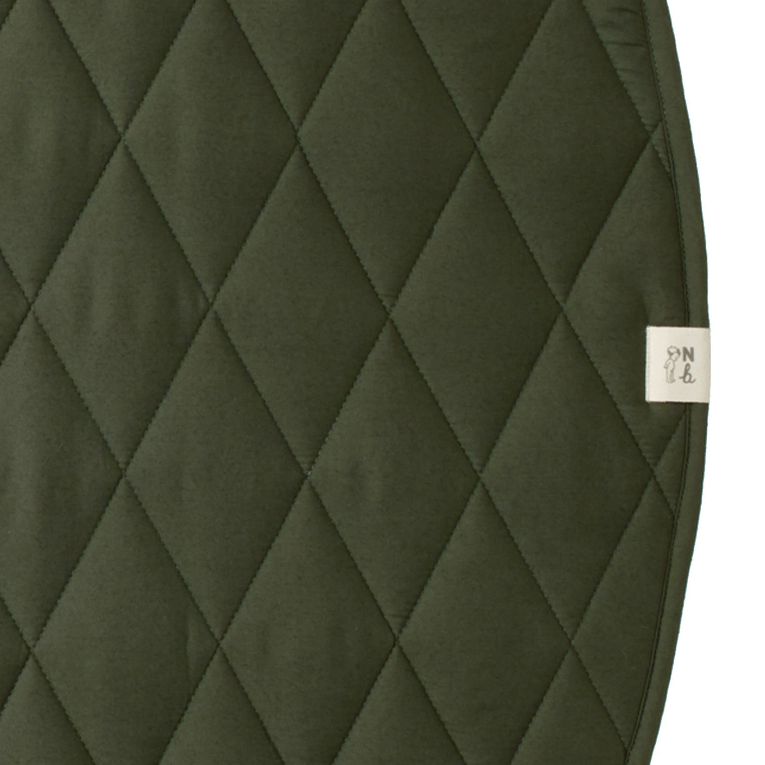 Quilted green fabric with a brand label on a white background