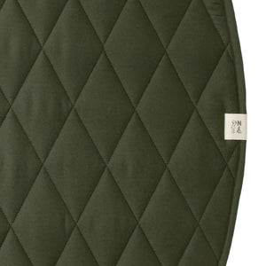 Quilted green fabric with a brand label on a white background