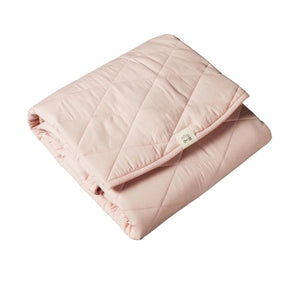 Pink quilted blanket on a white background