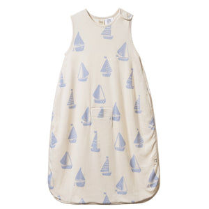 Beige baby sleeping bag with blue sailboat pattern on a white background