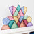 Colorful geometric transparent building blocks on a white surface