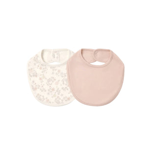 Two baby bibs on a plain white background, one in solid pale pink and one in off-white with a light floral print.