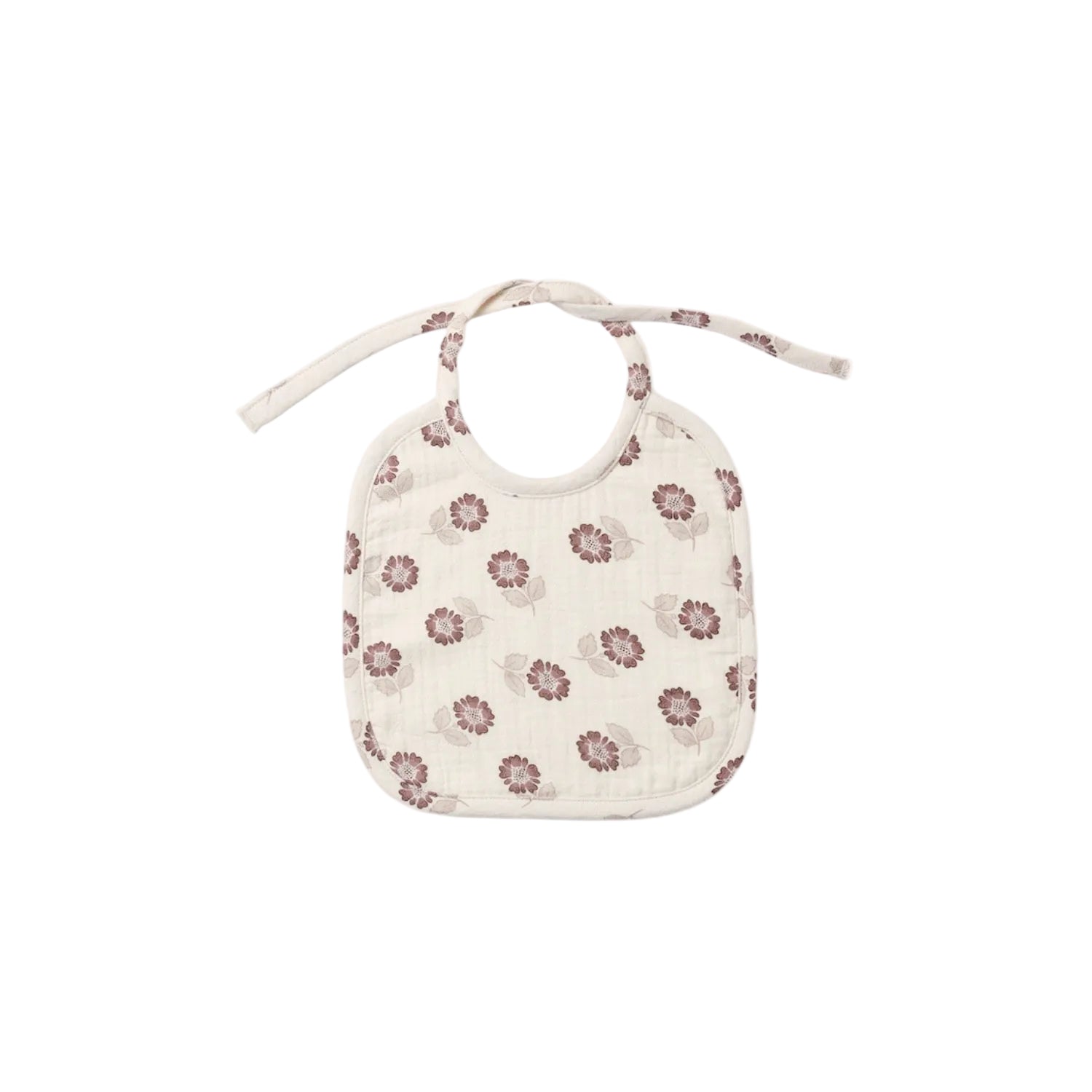 A cream-colored muslin baby bib with a small brown and pink floral pattern, featuring tie straps at the top, shown against a plain white background.