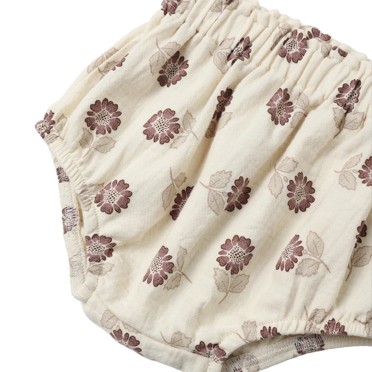 A baby girl's two-piece outfit set featuring a short-sleeve puff-sleeve smocked blouse and matching bloomers, both in a cream-colored cotton fabric with a brown floral pattern, shown on a plain white background.