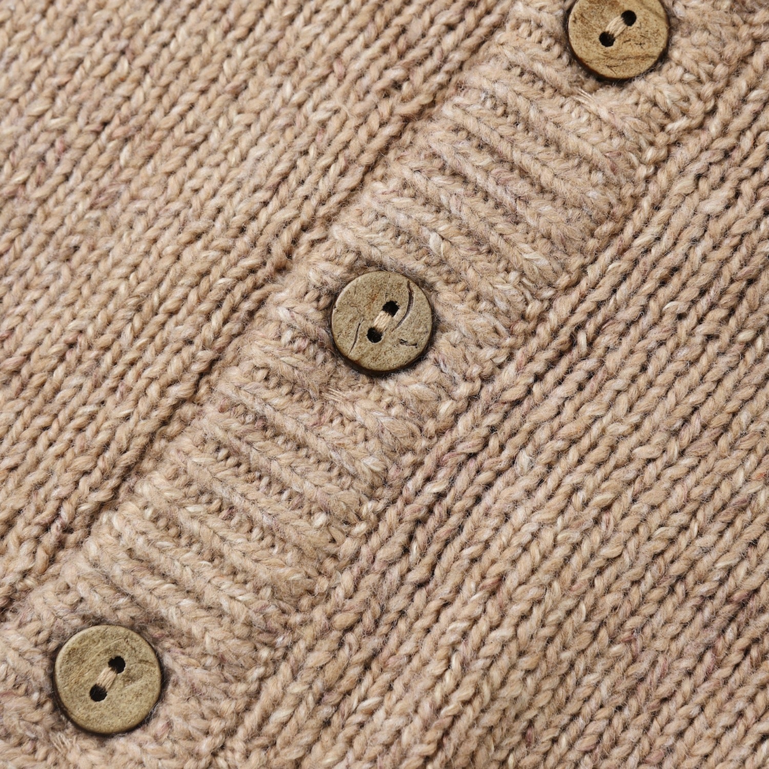 A baby knit cardigan sweater in a heathered light taupe-beige color, featuring a ruffled Peter Pan collar, button-front closure, and long sleeves, laid flat on a white background.