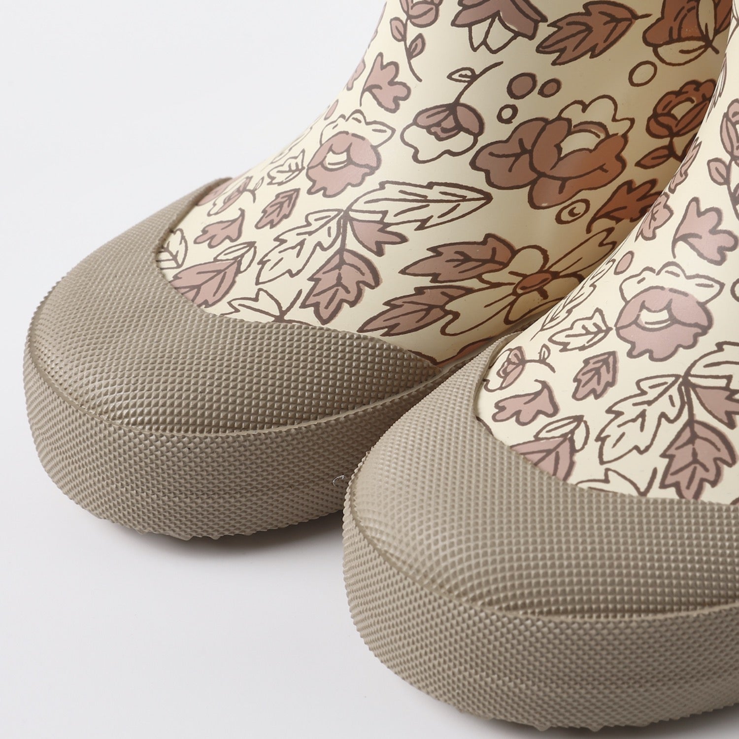 A pair of toddler rain boots with a beige and brown floral pattern, elastic side panels, and pull tabs, shown on a plain white background.