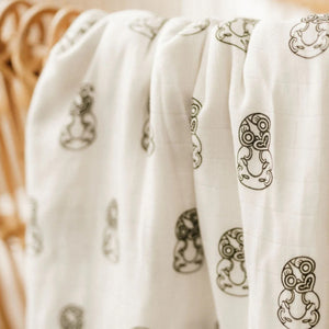 White baby wrap with dark green tiki 